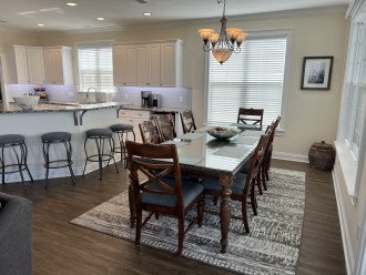 Dining table for 10, two folding chairs in laundry room and 5 barstools