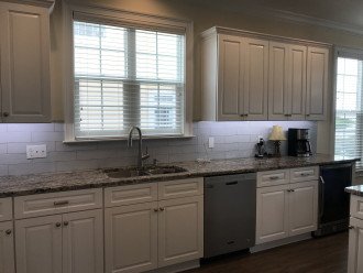 Newly remodeled kitchen with granite countertops and beverage cooler