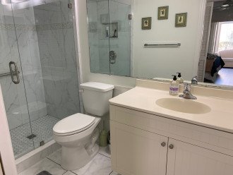 New tile shower with push/pull frameless door & comfort height toilet.