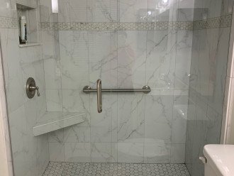 New master shower with niche, built in seat, sturdy grab bar in brushed nichol.