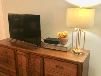 Roku smart tv in living room on new dresser tv stand.