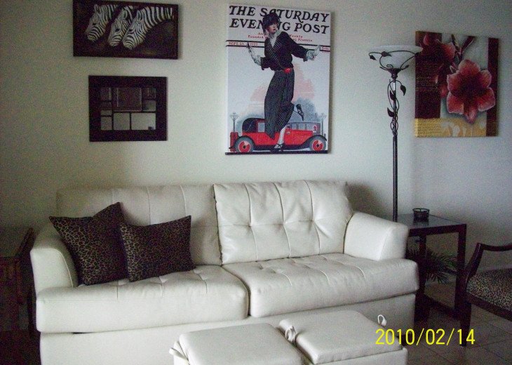 Living room with white leather sofa sleeper