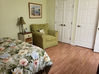Bedroom with sitting area, large closet and door to washer/dryer
