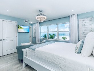 Primary bedroom with VIEW! Walk-in closet, 40" Smart TV & private lanai access.