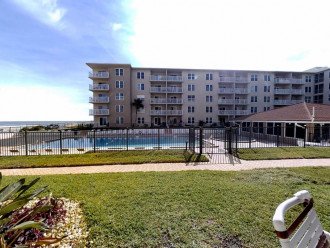 Patio view of clubhouse, pools and ocean