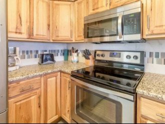 Kitchen includes oven/stove, microwave, toaster, coffee maker, and more.