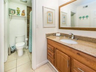 Bathroom features separated sinks from tub/toilet.