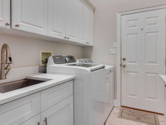 Laundry room has prep sink & heavy duty washer & dryer.