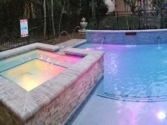 Salt water pool/spa comes alive at night with LED lights.