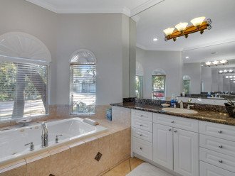 The master bathroom suite has double sinks, soaking tub, and shower.