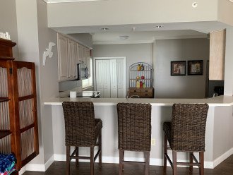 view from living area into kitchen. Breakfast bar