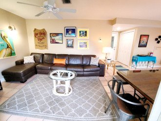 Large living area with comfortable couch, TV and interesting artwork