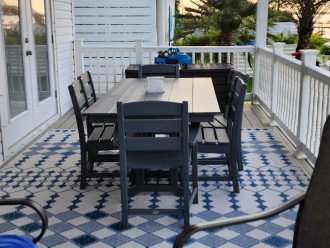 Outdoor porch with Plywood table chairs and BBQ.