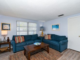 Spacious living room with seating for 5, flat panel HDTV off of the kitchen and dining room