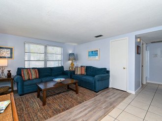 Spacious living room with seating for 5, flat panel HDTV off of the kitchen and dining room
