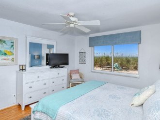 Master bedroom with king-size bed, HDTV, large bay window overlooking beach and Gulf, walk-in closet