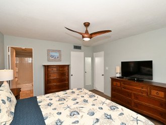Master bedroom with king-size bed, HDTV, large bay window overlooking beach and Gulf, walk-in closet, en suite bathroom