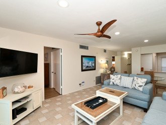 Spacious living room with HDTV, view to Lanai, beach and Gulf of Mexico