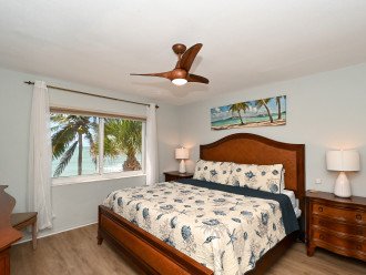Master bedroom with king-size bed, HDTV, large bay window overlooking beach and Gulf, walk-in closet, en suite bathroom