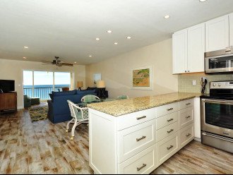 Modern, renovated, fully equipped kitchen with granite counters, glass tile backs splash...