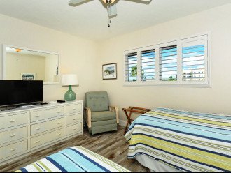 2nd bedroom with two twin-size beds, HDTV, large window overlooking the bay and boat docks
