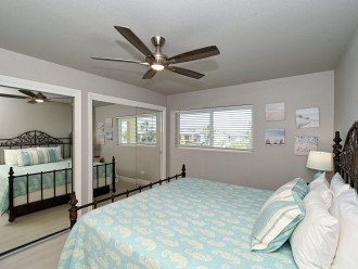 2nd bedroom with king-size bed, large window overlooking the bay and boat docks, HDTV