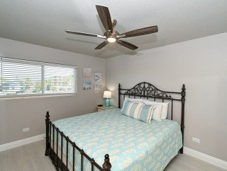2nd bedroom with king-size bed, large window overlooking the bay and boat docks, HDTV