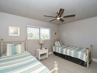3rd bedroom with two twin-size bed, HDTV, large window overlooking the bay and boat docks