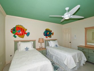 3rd bedroom with two twin-size beds, HDTV, large window overlooking the bay and boat docks
