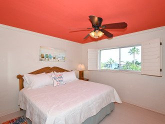 2nd primary bedroom with king-size bed, large window overlooking the bay and boat docks, HDTV