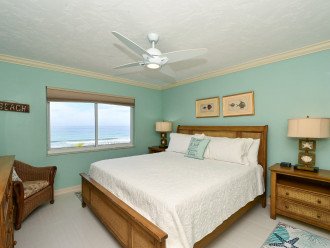 Primary bedroom with bay window overlooking the Gulf and beach below. King-size bed with large HDTV