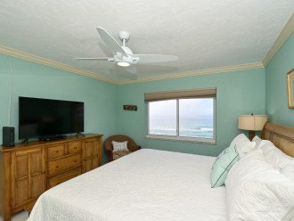 Primary bedroom with bay window overlooking the Gulf and beach below. King-size bed with large HDTV