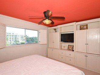 2nd primary bedroom with king-size bed, large window overlooking the bay and boat docks, HDTV