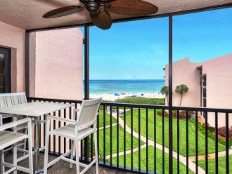 Floor-to-ceiling sliders open to spacious Lanai with stunning views of world famous Crescent Beach and the Gulf, with the pool and tropical landscaping below.