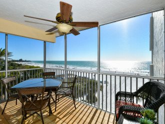 Lanai with table and chairs & love seat...stunning views of the azure waters of the Gulf and the powder white sands of World famous Crescent Beach.
