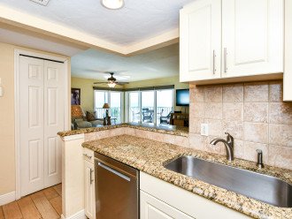 Modern, fully equipped kitchen with granite counters and all stainless appliances