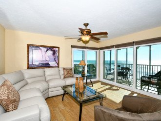 Large living room combined with sliders out to Lanai - spectacular views of world famous Crescent Beach and the Gulf of Mexico. Large flat panel HDTV, leather sectional...