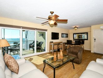 Large living room combined with sliders out to Lanai - spectacular views of world famous Crescent Beach and the Gulf of Mexico. Large flat panel HDTV, leather sectional...