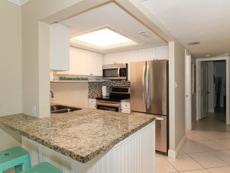 Modern, fully equipped kitchen with granite counters and all stainless appliances