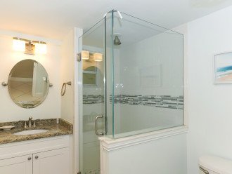2nd Bathroom with granite countertop, beautiful modern tile and glass walk-in shower