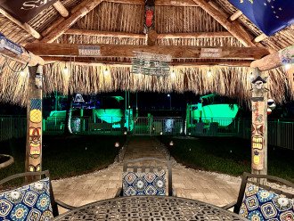 Tiki hut with hanging lights and water view. Enjoy the tiki torches and lighting