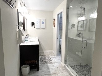 Master 1 has double vanity, makeup mirror, glass shower, and water closet