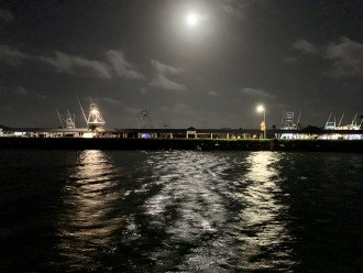 Moonlight view of the wide canal. Marina lights can be seen at night.