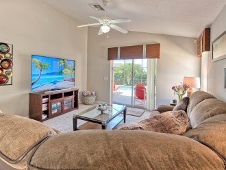 Family room with large smart TV and access to pool deck